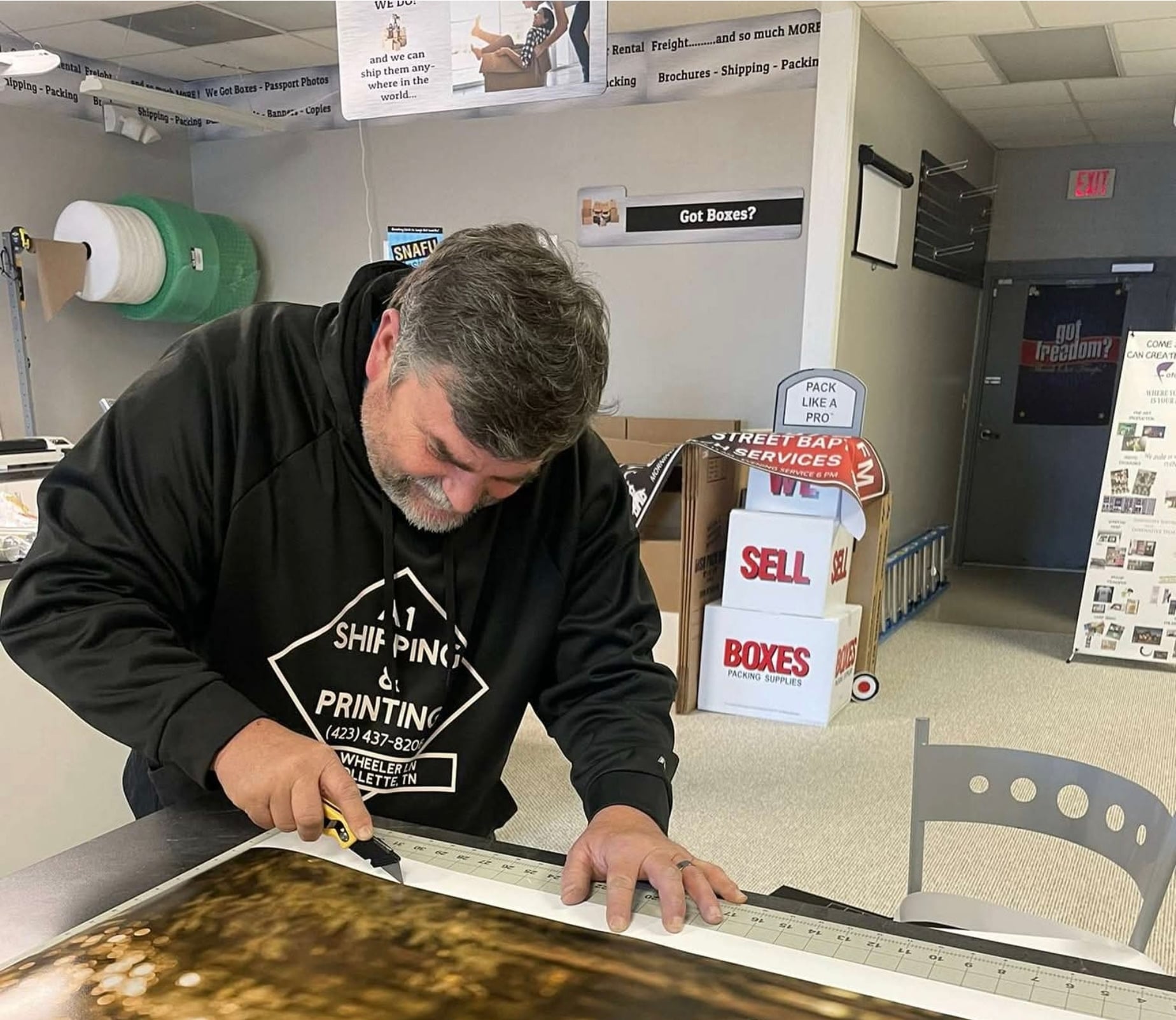 Bryan, owner of A1 Shipping & Printing, working on a custom project